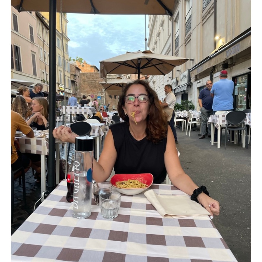 Woman eating a carbonara pasta in Italy